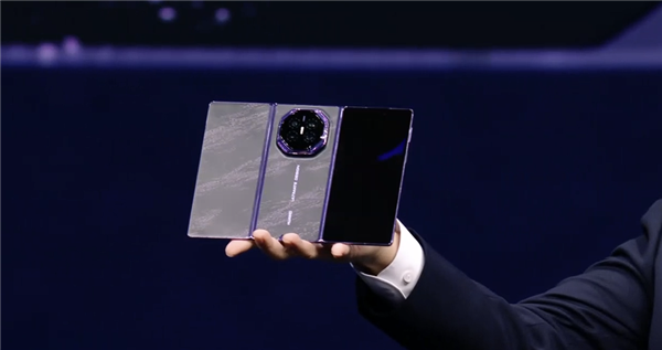 Huawei Mate XT 2 held open, showing the tri-fold form factor